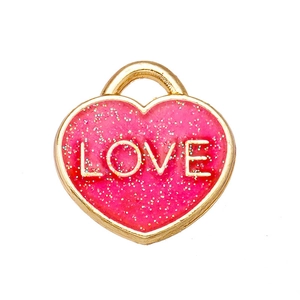 Macro shot of rose red heart LOVE charm with gold trim and glitter for jewelry making