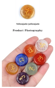 Detailed set of seven chakra natural stones with golden engraved yoga symbols