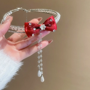 Detail of red bow pearl necklace with sparkling diamond tassels and teardrop pendants