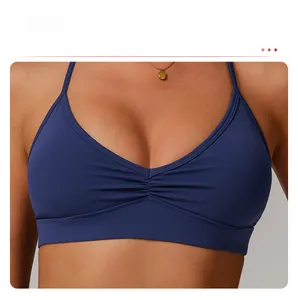 Detailed view of the dark blue sports bra featuring a chic ruched front design detail