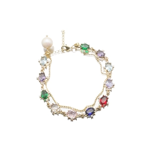 Elegant gold double-layer bracelet with colorful gemstones and a white pearl charm