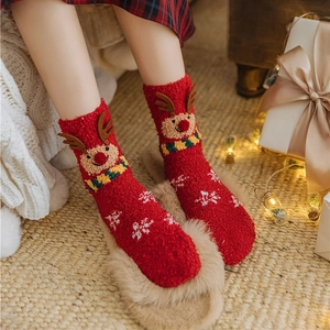 Thick coral fleece Christmas socks in red featuring reindeer and snowflake patterns