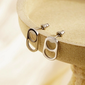 Minimalist silver can tab earrings with a brushed metal finish and industrial design