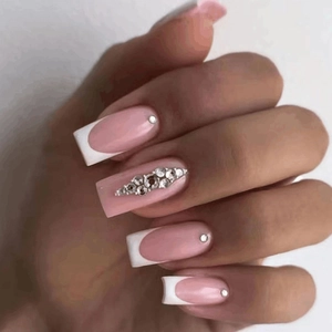 Long square French press-on nails with pink base, white tips and rhinestone accents