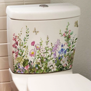 Detailed close-up of vibrant floral and butterfly self-adhesive decals on a bathroom surface