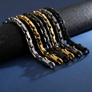 Detail of square box chain bracelets in silver, gold, black, and grey stainless steel
