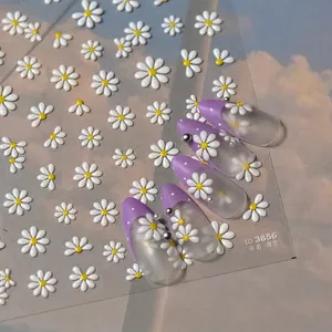 3D white daisy jelly nail stickers with yellow centers and silver beads on purple base