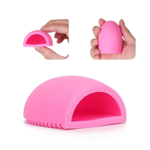 Macro detail of a pink silicone makeup brush cleaner egg with textured cleaning surface