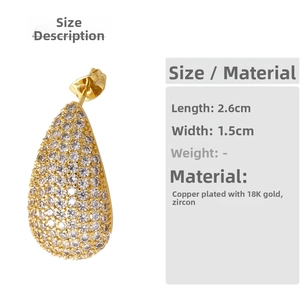 Detail view of gold teardrop earrings with dimensions 2.6cm by 1.5cm and cubic zirconia