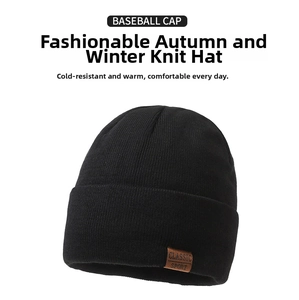 Close-up of black knitted beanie featuring a classic sport leather label detail