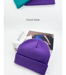 Detail of purple and teal knit beanies with a thick ribbed cuff for winter warmth