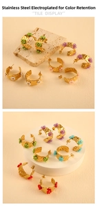 Detail of 18K gold-plated C-shaped stainless steel earrings with beaded flower charms