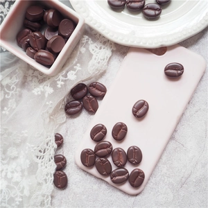 Pink phone case decorated with realistic 3D brown resin coffee beans on marble surface
