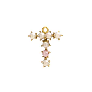 Macro detail of T-shaped shell pearl pendant with gold plating and letter design