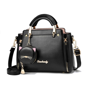 Large black leather tote bag with shoulder strap and cute cat-shaped coin purse pendant