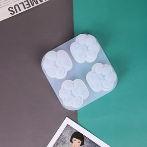 Detailed top view of 4-cavity cat paw silicone mold with heart details for DIY crafts