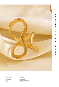 Detailed view of an 18K gold plated stainless steel ring with a modern criss-cross design