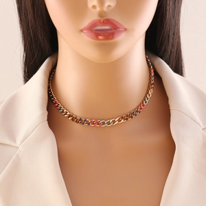 Colorful enamel Cuban link necklace in gold finish worn with a stylish beige blazer
