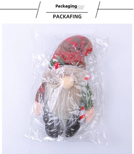 Detailed view of Christmas gnome plush in plastic packaging with knitted hat and white beard
