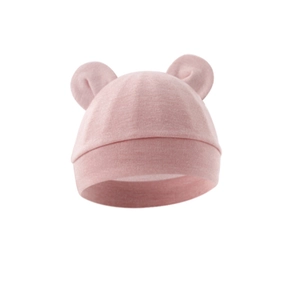 Detailed close-up of pink baby knit hat with cute bear ears and ribbed cotton texture
