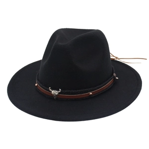 Detail of a black felt cowboy hat featuring a leather band and silver bull head ornament