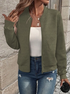 Detail of army green bomber jacket featuring a unique 3D geometric embossed texture