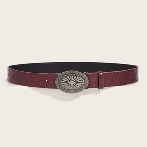 Deep red crocodile embossed leather belt for women with a vintage silver sunburst buckle