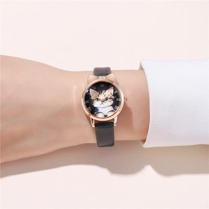 Close-up of cat-themed watch featuring rose gold cat ear case and Roman numerals