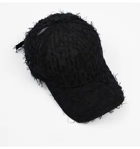 Detailed top view of black baseball cap with distressed fringe and ripped texture details