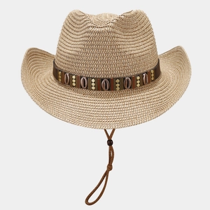 Detail of straw cowboy hat with brown leather band featuring shell and rivet accents