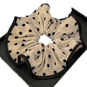 Oversized beige polka dot scrunchie with black satin edges for elegant hairstyles