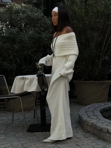 Detail of off-the-shoulder white ribbed knit dress with long sleeves and ankle-length cut