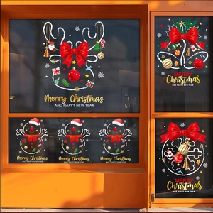 Macro detail of Christmas reindeer and bells static window stickers on festive shop glass