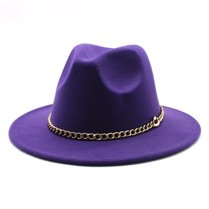 Detail of purple fedora hat featuring a chunky gold metal Cuban chain band decoration