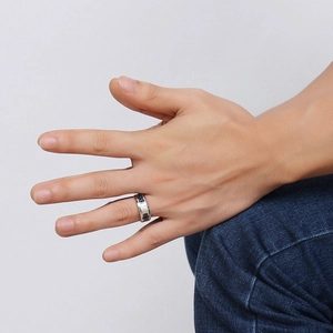 Close-up of 8mm stainless steel ring with black carbon fiber inlay worn on male hand