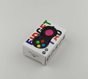 Close-up of black fidget pad toy in white retail packaging with colorful buttons