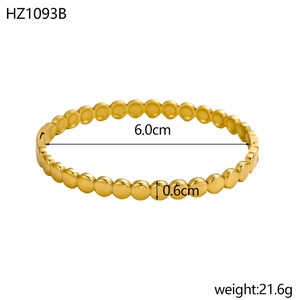 Macro shot of 18K gold plated beaded open bangle with dimensions 6.0cm by 0.6cm