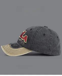 Detail of vintage washed cotton baseball cap with LA embroidery and contrast visor