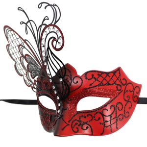 Macro detail of red and black masquerade mask with glitter and butterfly wing decor