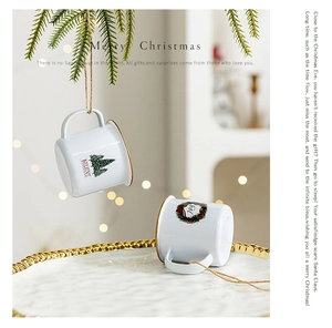 Close-up of white metal Christmas ornaments with festive patterns and holiday typography