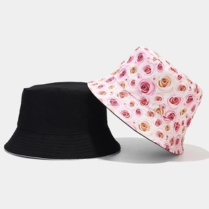 Detail view of double-sided cotton sun hat featuring floral prints and solid black fabric