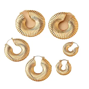 Set of six gold hoop earrings with pleated texture in varying sizes on white background