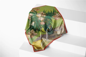 Detailed close-up of a floral oil painting silk scarf with elegant red hand-rolled edges