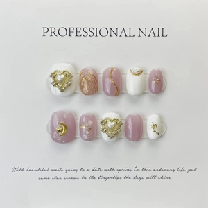 Detailed view of silver sparkly press-on nails with 3D heart pearls and gold foil accents