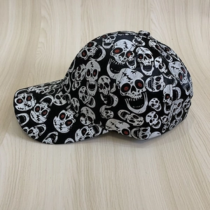 Punk black baseball cap with white skull prints and red accents, stylish street headwear