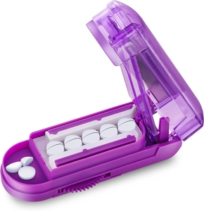 Detail view of purple multi-pill cutter with visible slots and precise cutting blades