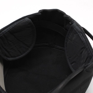 Detail view of the warm quilted ear flaps and soft fleece lining of this winter men's cap