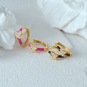 Macro detail of colorful enamel butterfly hoop earrings with sparkling white zircons