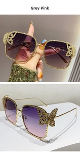 Detailed view of butterfly-shaped crystal-embellished temples on gold metal sunglasses