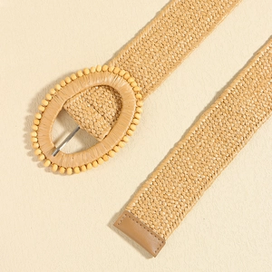 Straw woven stretch waist belt with decorative oval beaded buckle and leather tip